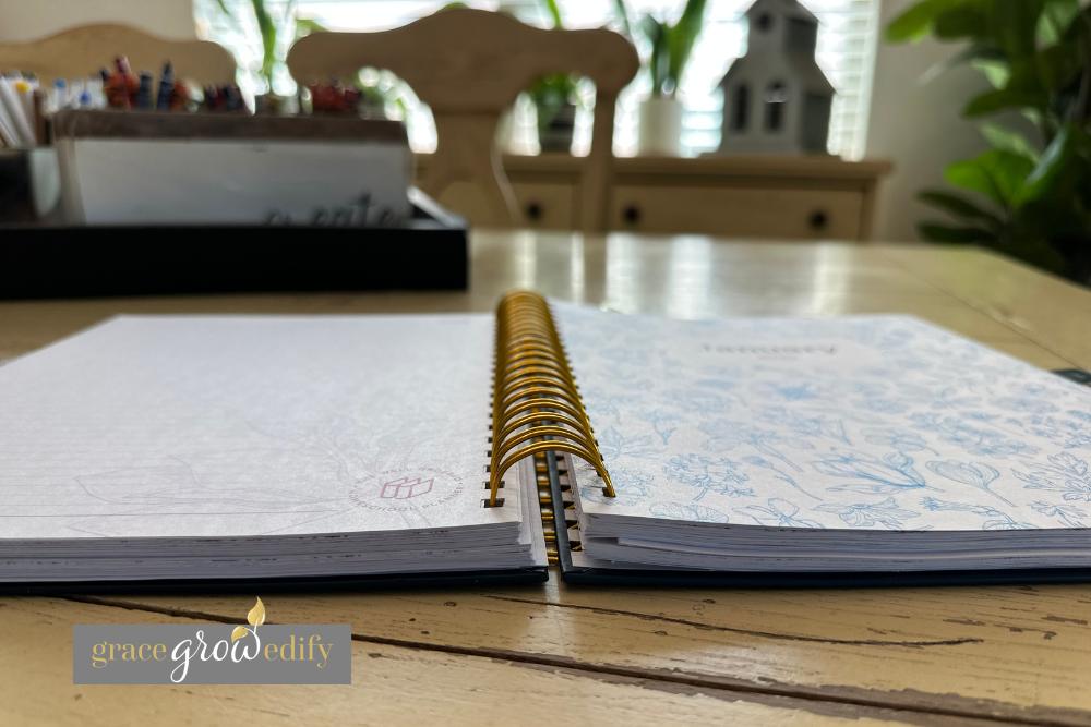 Flat lay photo of The Well Ordered Homeschool Planner showing the metal coil binding that lays flat for easy homeschool planning.
