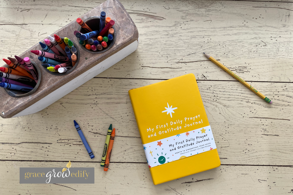 Flat lay of a Christian gratitude journal for kids with a colorful cover, featured in our homeschool journaling routine.